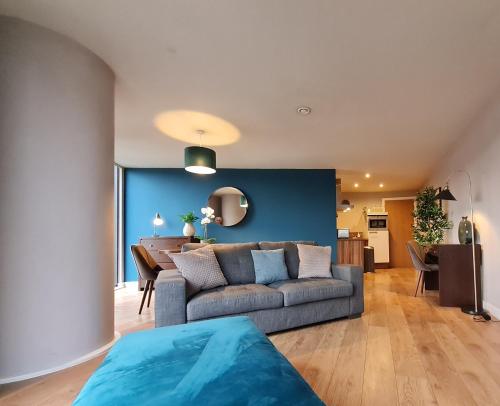 a living room with a couch and a dining room at Spacious City Centre 2 bedroom apartment in Sheffield