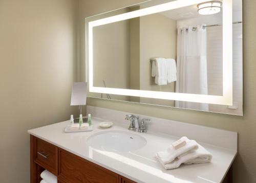 a bathroom with a sink and a large mirror at Stonewall Resort in Roanoke