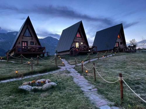 a group of cottages with a path in front of them at Etno selo Smrčevo brdo in Žabljak