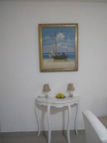 a table with a picture of a boat on the beach at Apartment in Ciudad Juan Bosch. in Los Paredones