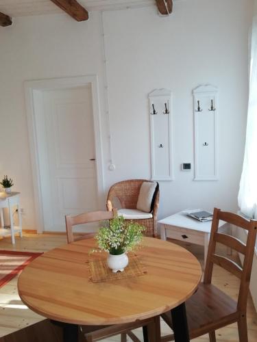 a dining room with a wooden table and chairs at Pālena apartamenti in Tērvete