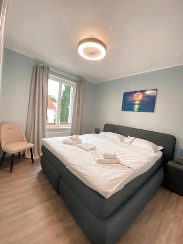 a bedroom with a large bed with white sheets at Villa Seebach in Boltenhagen