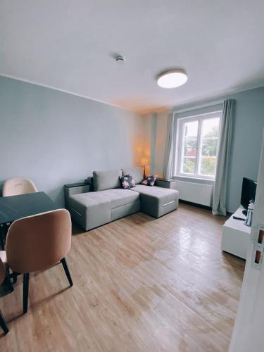 a living room with a couch and a window at Villa Seebach in Boltenhagen