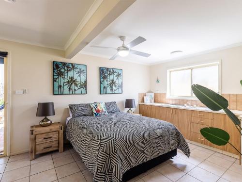 a bedroom with a bed and a window at The Birubi Beach House 11 Campbell Ave Close to the beach pet friendly holiday home in Anna Bay