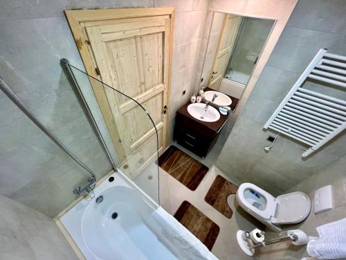 a bathroom with a tub and a toilet and a sink at Dream Studio Silver Mountain in Poiana Brasov