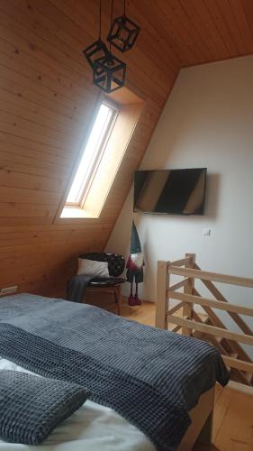 a bedroom with a bed and a skylight at Vučko Apartman U532 in Jahorina