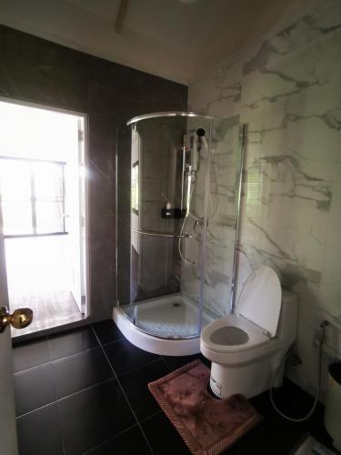 a bathroom with a shower and a toilet at The Balcony pool villa in Ban Khanong Phra Nua