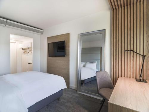 a hotel room with a bed and a tv at Radisson Blu Hotel Tromsø in Tromsø