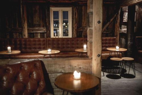 a room with a couch and tables and candles at Radisson Blu Hotel Tromsø in Tromsø