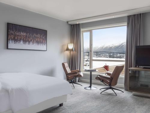 a hotel room with a bed and a large window at Radisson Blu Hotel Tromsø in Tromsø