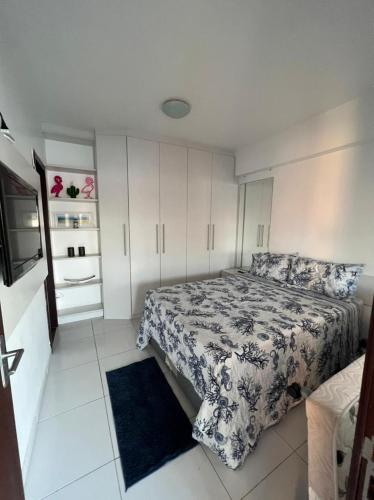 a small bedroom with a bed and a kitchen at Casa Marambaia in Rio de Janeiro