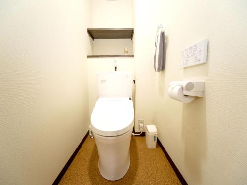 a small bathroom with a toilet in a stall at Kevin's Place in Kyoto