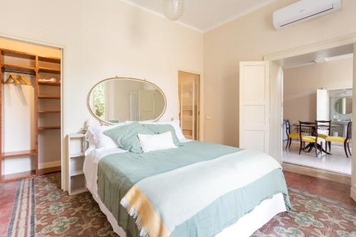 a bedroom with a large bed and a mirror at PALAZZO SABBIONI CAMERA ROMANTICA della DUCHESSA in Ferrara