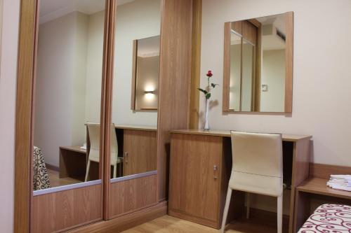 a hotel room with a desk and a mirror at Pontus Veteris in Sanxenxo