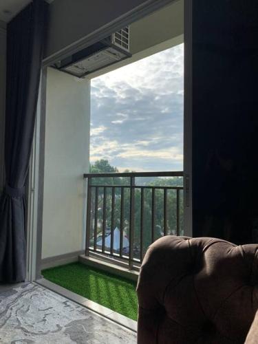 a room with a balcony with a large window at Inap Kayangan @ Puncak Alam with Swimming Pool in Bandar Puncak Alam