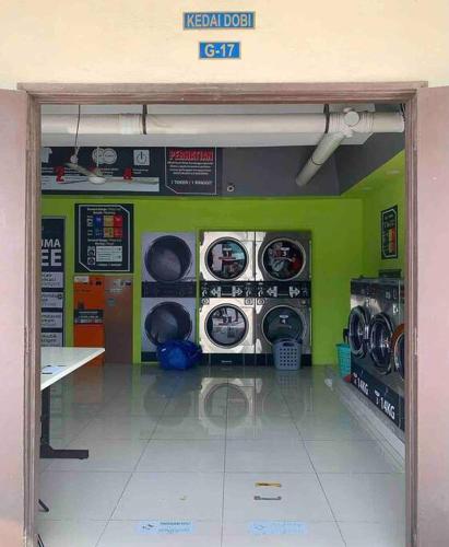 a laundry room with washers and dryers in a store at Inap Kayangan @ Puncak Alam with Swimming Pool in Bandar Puncak Alam