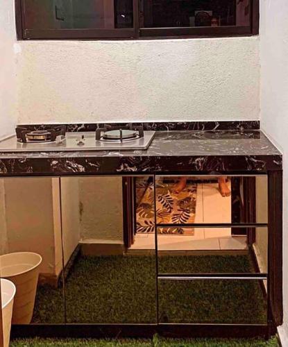 a kitchen with a stove and a counter top at Inap Kayangan @ Puncak Alam with Swimming Pool in Bandar Puncak Alam