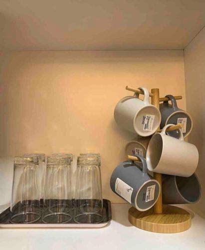 a kitchen counter with wine glasses and coffee mugs at Inap Kayangan @ Puncak Alam with Swimming Pool in Bandar Puncak Alam
