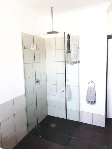 a shower with glass doors in a bathroom at Criterion Hotel Grenfell in Grenfell