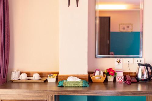a wooden counter top with various items on it at Palm Coco Mantra in Lamai