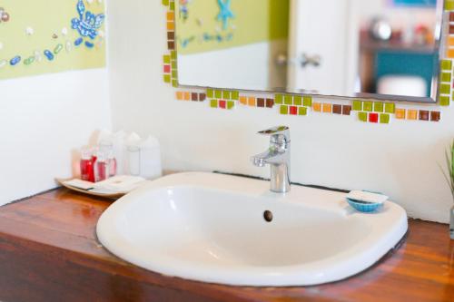 a white sink in a bathroom with a mirror at Palm Coco Mantra in Lamai
