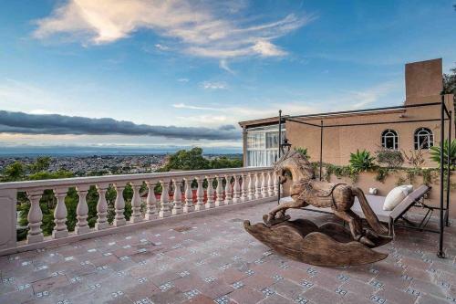 a statue of a lion sitting on a balcony at Casa Vista 6BR Villa, 16p Jacuzzi Pool, Staff & Breakfast in San Miguel de Allende