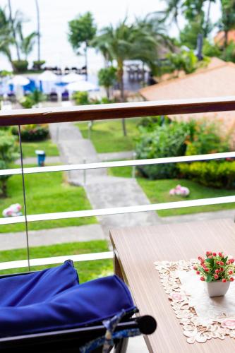 a blue chair on a balcony with a view of a street at Palm Coco Mantra in Lamai