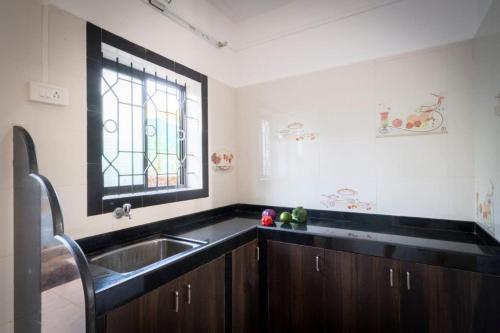 a kitchen with a sink and a window at De Lavender Luxury sea view Guest Houses in Agonda