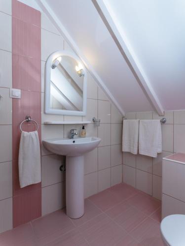 a bathroom with a sink and a mirror at Petite Sirene Studios in Paralia Katerinis