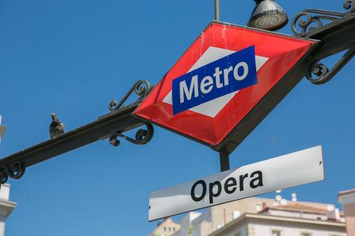 a metro sign hanging from a street light at Hostal Central Palace Madrid in Madrid