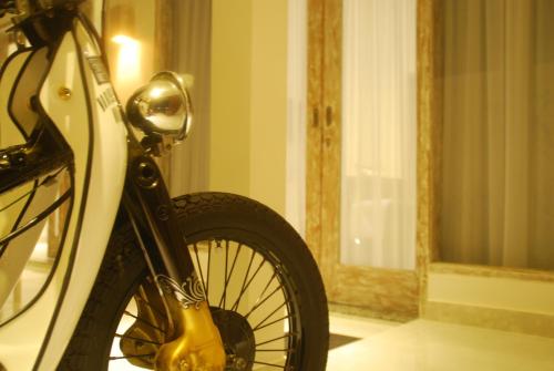 a bike parked in front of a room with a window at Sugiras Living in Denpasar