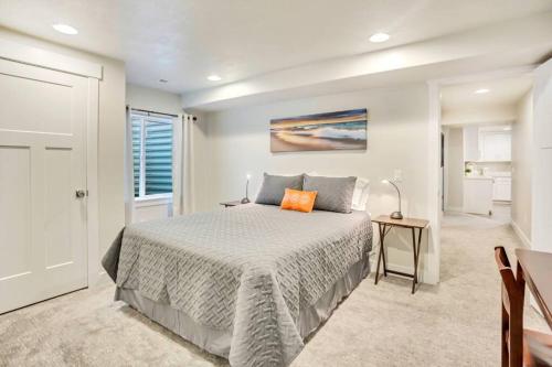 a bedroom with a bed with an orange pillow on it at New Furnished 2Bd Apt! Great for Long Stays in Vineyard
