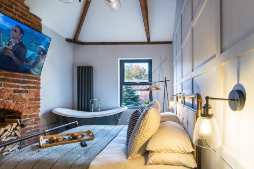 a bedroom with a bed and a bath tub in a room at The Secret Cottage - Morpeth in Morpeth