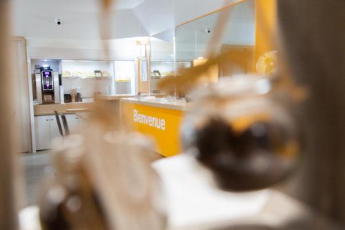 a kitchen with a yellow counter in a kitchen at Class'Eco Namur in Namur