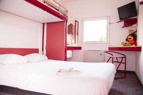a hotel room with a white bed and a window at Class'eco Liège in Liège