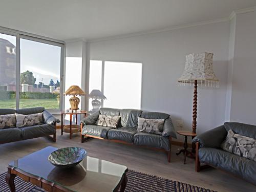 a living room with couches and a table at Ocean-Song in Strand