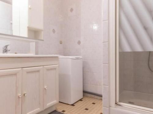 a white bathroom with a sink and a washing machine at Gîte Le Landreau, 3 pièces, 5 personnes - FR-1-306-794 in Le Landreau