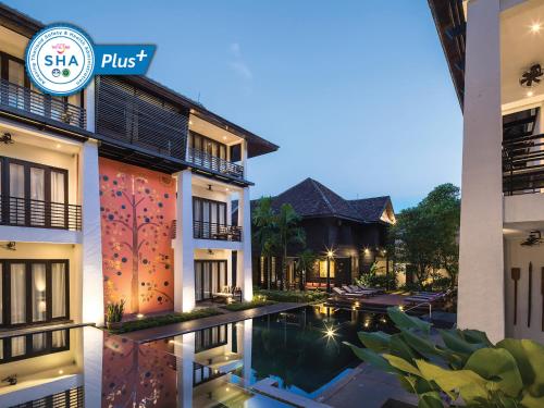 una villa con piscina por la noche en U Chiang Mai, en Chiang Mai
