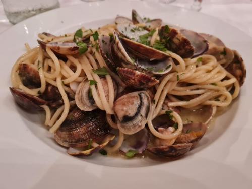 a plate of pasta and mushrooms on a white plate at il Glicine B&B RISTORANTE in Cazzago San Martino