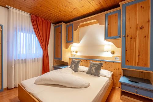 Ένα ή περισσότερα κρεβάτια σε δωμάτιο στο Albergo Dolomiti