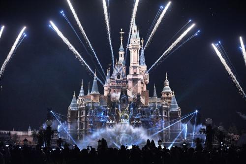 a nighttime picture of cinderella castle with fireworks at Manli Hotel Shanghai Pudong Airport Branch -Provide free shuttle buses to Pudong Airport and Disneyland in Shanghai
