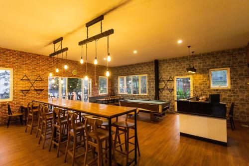 a large room with a ping pong table and a pool table at Batuque Town Villa 2 in Batu