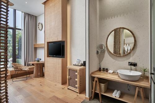 a bathroom with a sink and a mirror at Manli Hotel Shanghai Pudong Airport Branch -Provide free shuttle buses to Pudong Airport and Disneyland in Shanghai