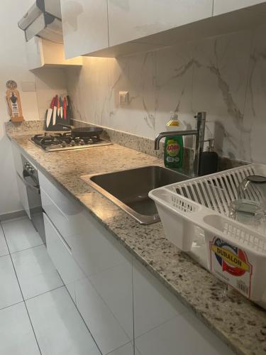 a kitchen counter with a sink and a stove at Atmospheric apartment with a beautiful view of the swimming pool in Bayahibe