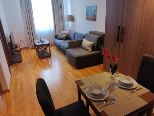 a living room with a table and a couch at Bela Jela - Brzeće, Kopaonik in Brzeće