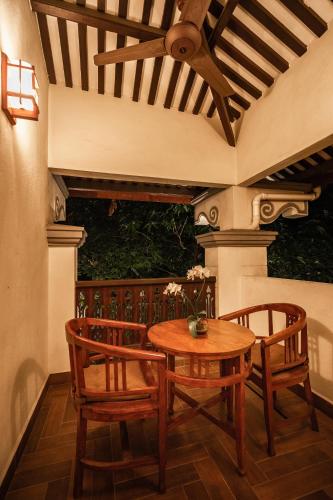 a patio with a wooden table and two chairs at Hotel Penaga in George Town