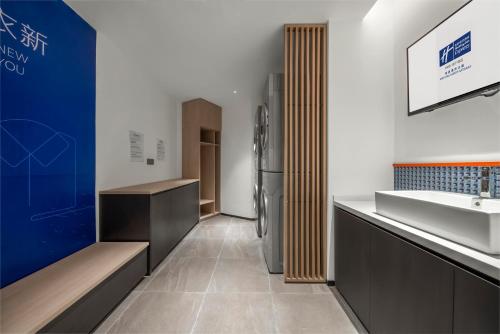 a kitchen with a refrigerator and a sink at Holiday Inn Express Nantong North Gateway, an IHG Hotel in Nantong