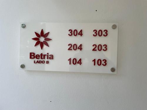 a sign on a wall with a clock on it at Atmospheric apartment with a beautiful view of the swimming pool in Bayahibe