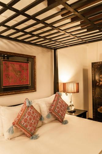 a bedroom with a bed with pillows on it at Hotel Penaga in George Town