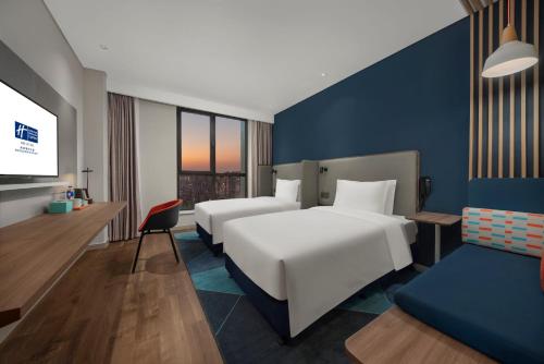 Ένα ή περισσότερα κρεβάτια σε δωμάτιο στο Holiday Inn Express Nantong North Gateway by IHG